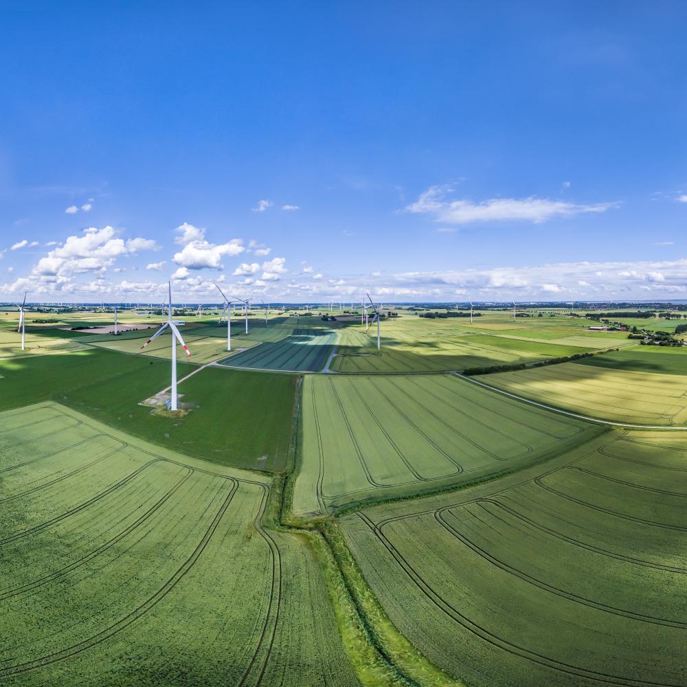 European countryside dotted with windmills on a mostly sunny day